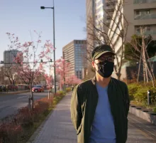 Men stands with mask. Photo by Simon Ma on Unsplash.