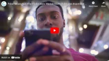 Man holding cellphone. Screenshot of video. 