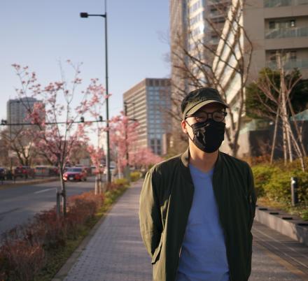 Men stands with mask. Photo by Simon Ma on Unsplash.